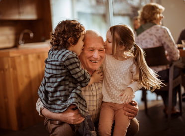 Kids kissing grandparent on forehead - benefits of whole life insurance